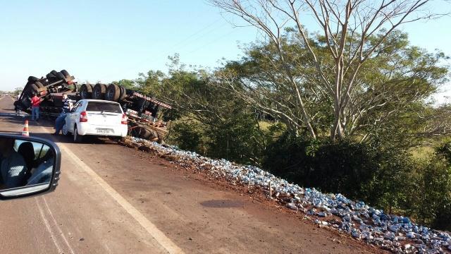 Caminhão carregado de cerveja tomba e carga fica espalhada